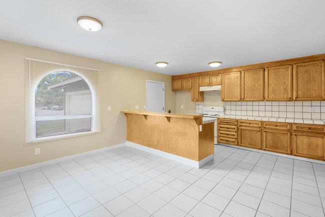 6790 Filbro Drive Gilroy, CA 95020 - Photo 13 of 42 a kitchen with a stove a sink and a refrigerator