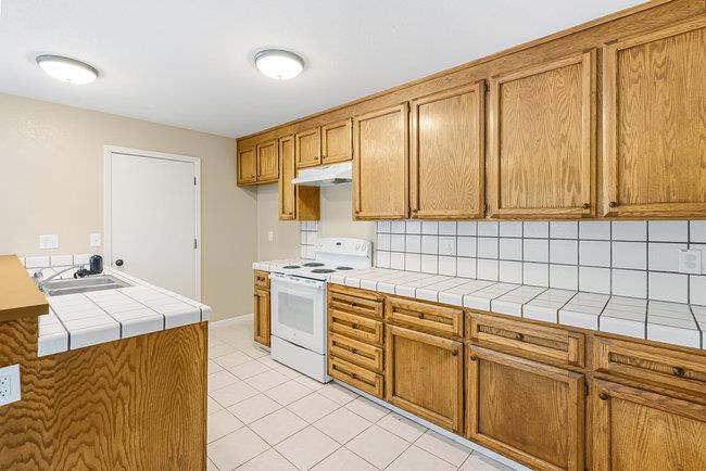 6790 Filbro Drive Gilroy, CA 95020 - Photo 14 of 42 a kitchen with stainless steel appliances granite countertop a sink stove and cabinets