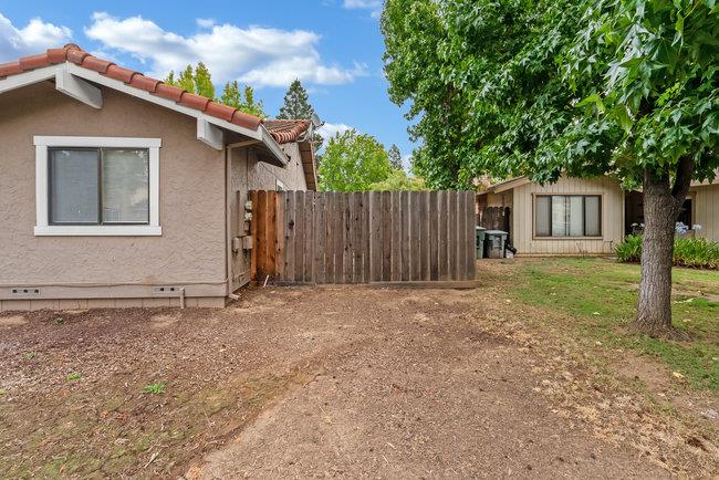 6790 Filbro Drive Gilroy, CA 95020 - Photo 37 of 42 a backyard of a house with lawn chairs and wooden fence