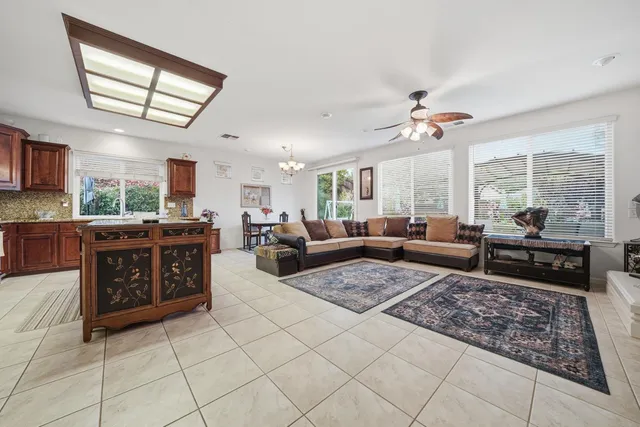 a living room with furniture and a chandelier