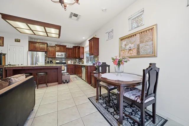 a kitchen with stainless steel appliances granite countertop a stove and a refrigerator