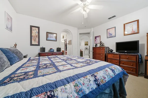 a bedroom with furniture and a book shelf