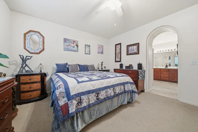 a spacious bathroom with a double vanity sink toilet and shower