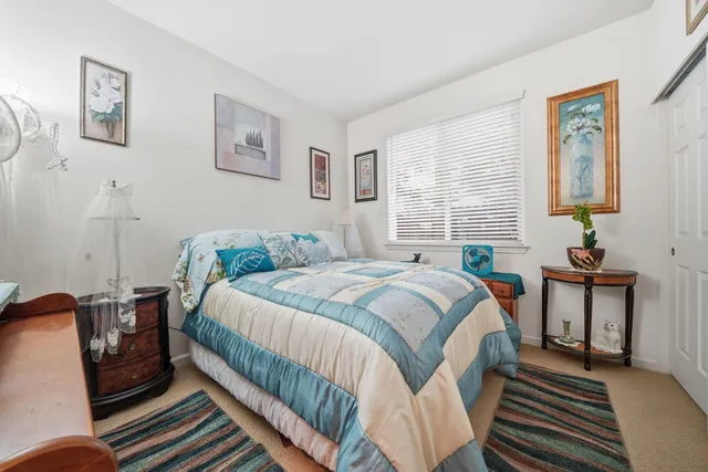 a bed room with a bed and a wooden floor