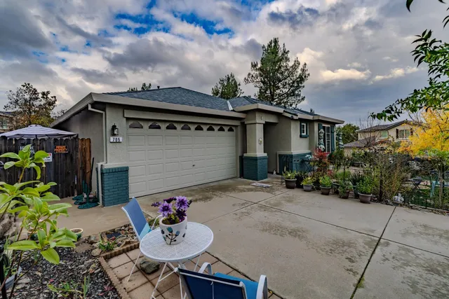 a front view of a house with garden