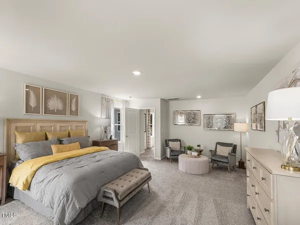a spacious bedroom with a bed and window