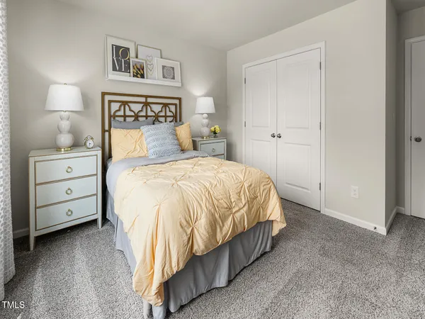 a bedroom with a bed and a night stand