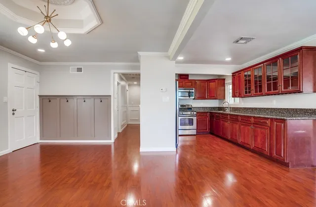 a kitchen with stainless steel appliances granite countertop a refrigerator stove and sink