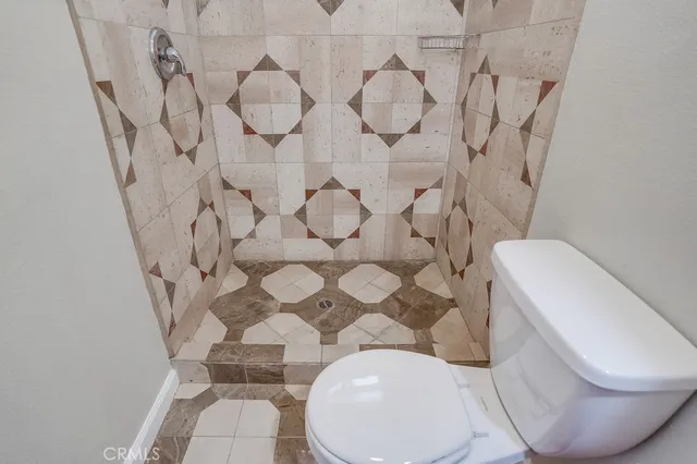 a view of a livingroom with wooden floor and a flat screen tv