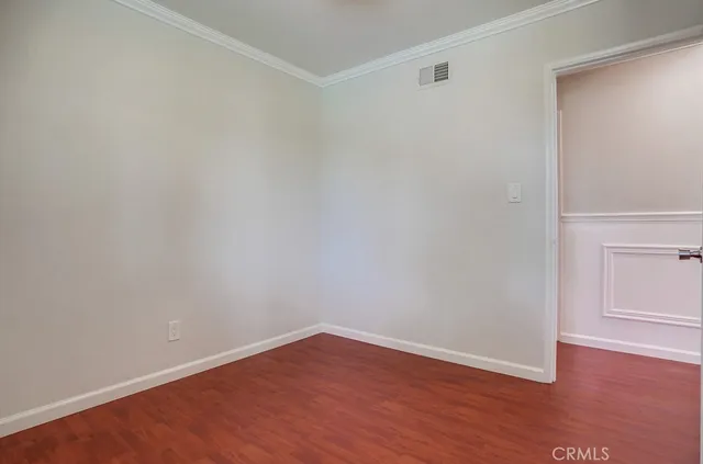 a front view of a house with a yard and a garden