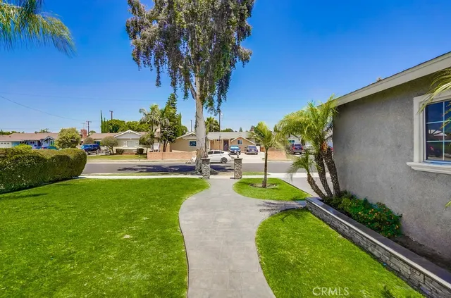 a living room with stainless steel appliances kitchen island a large island in the center