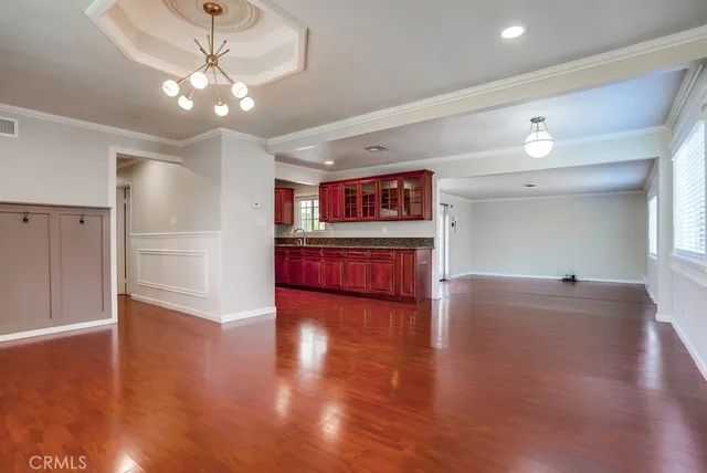 a view of kitchen with microwave a stove and wooden floor