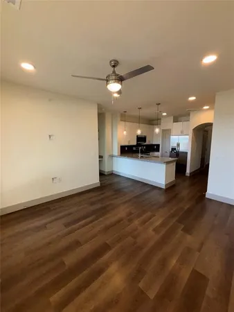 a view of a kitchen with a sink and a stove top oven