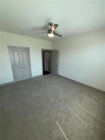 a view of empty room with ceiling fan
