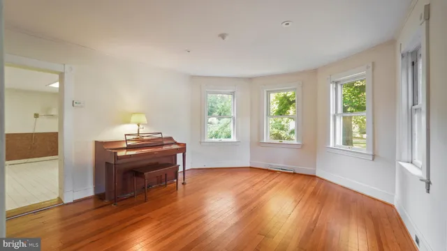 a view of room with window and wooden floor