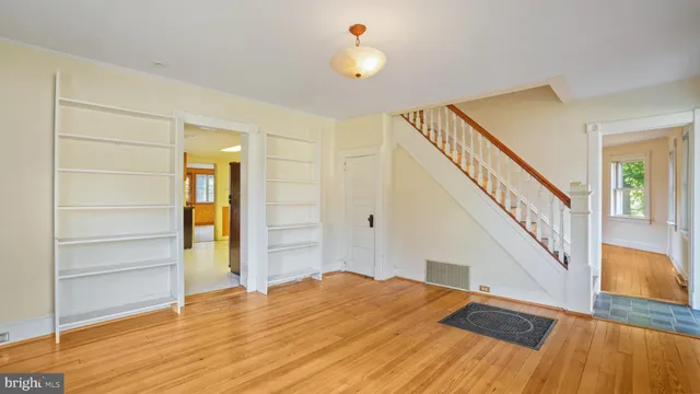 a view of a room with wooden floor and stairs