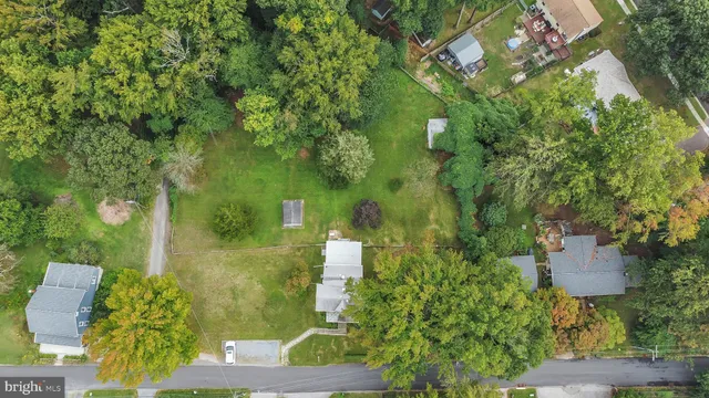 an aerial view of a house with swimming pool and garden space