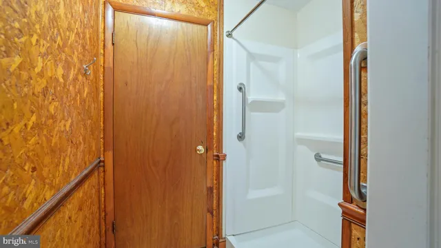 a bathroom with a shower and a door