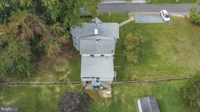 an aerial view of a house with a yard
