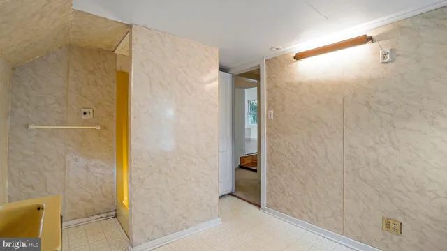 a bathroom with a shower and a glass door