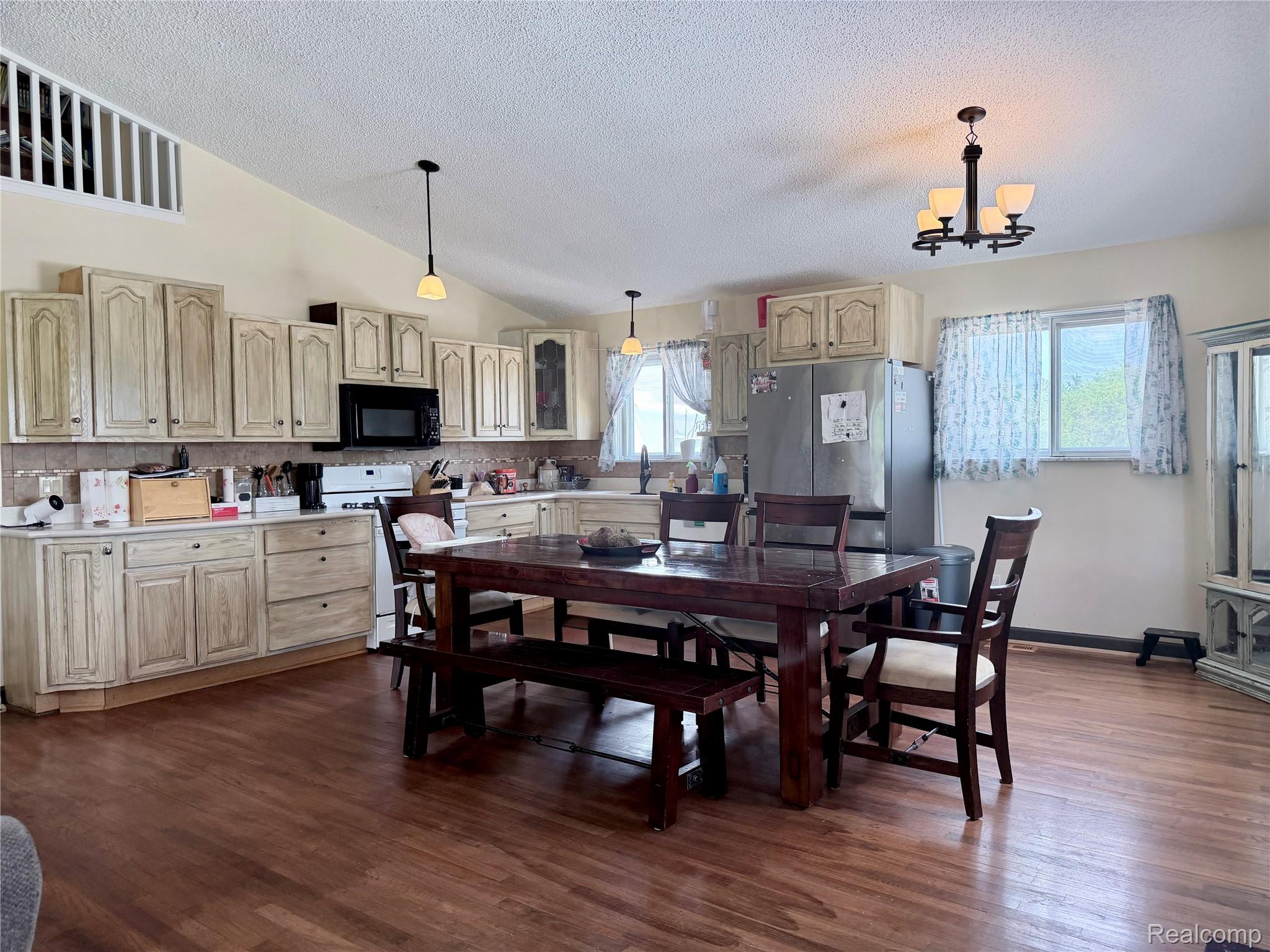 10865 Norman Road Yale, MI 48097 - Photo 7 of 23 Kitchen featuring wood-finish flooring, vaulted ceilings, and light-toned cabinetry