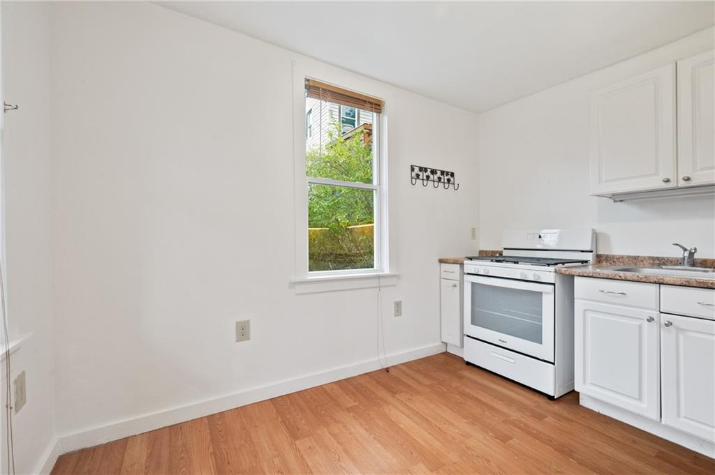 701 Maple Way Oakmont, PA 15139 - Photo 4 of 26 a kitchen with a white cabinets and wooden floor