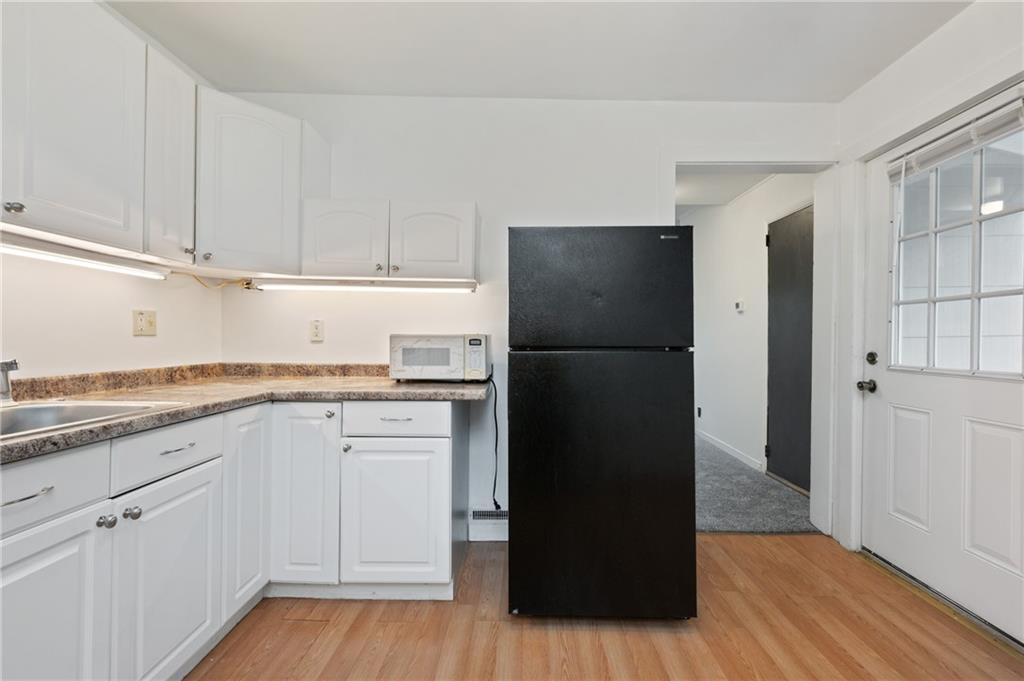 701 Maple Way Oakmont, PA 15139 - Photo 7 of 26 a kitchen with a refrigerator and cabinets