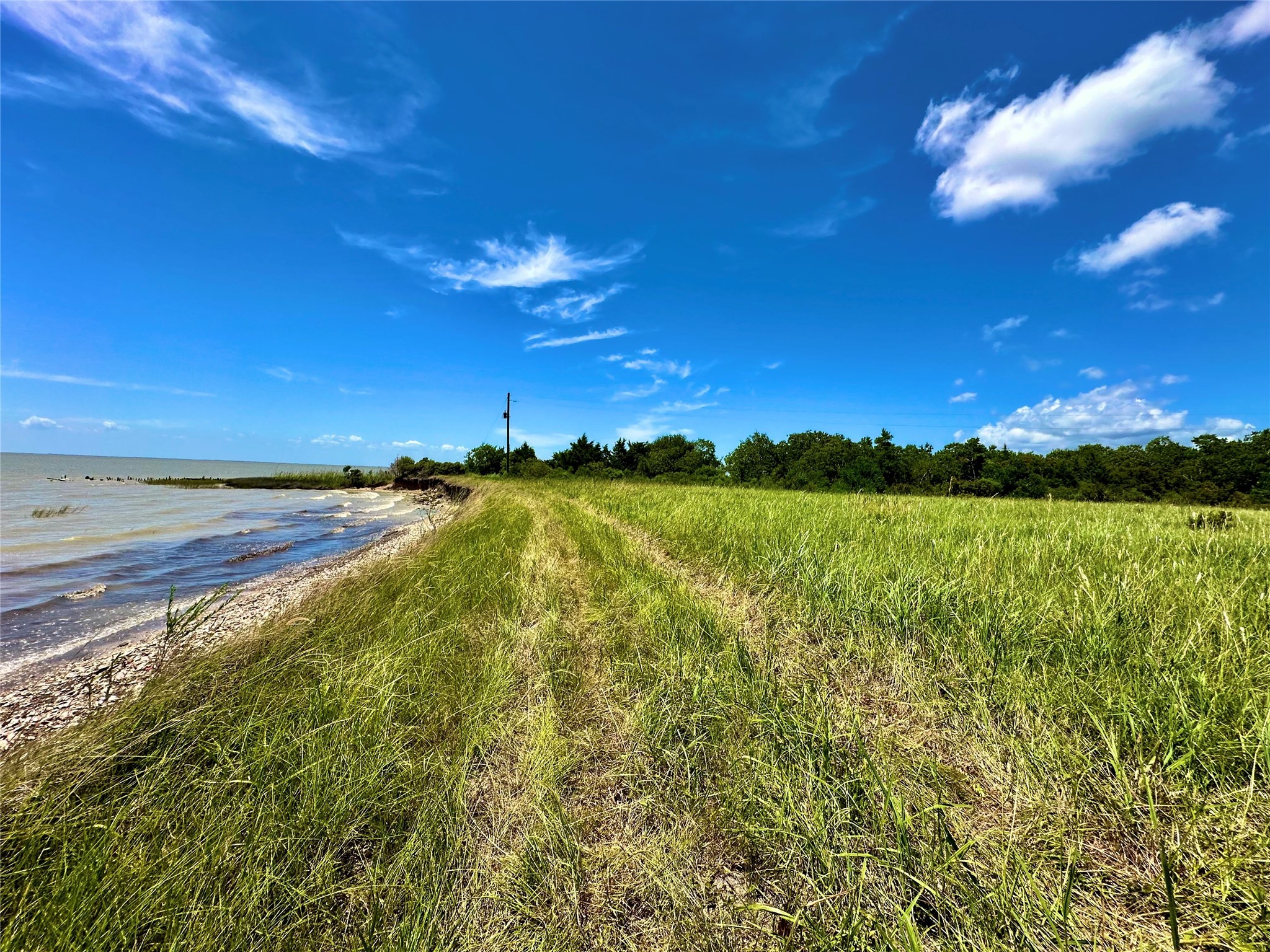 2101 West Bayshore Road Anahuac, TX 77514 - Photo 2 of 10 a view of an ocean and a building