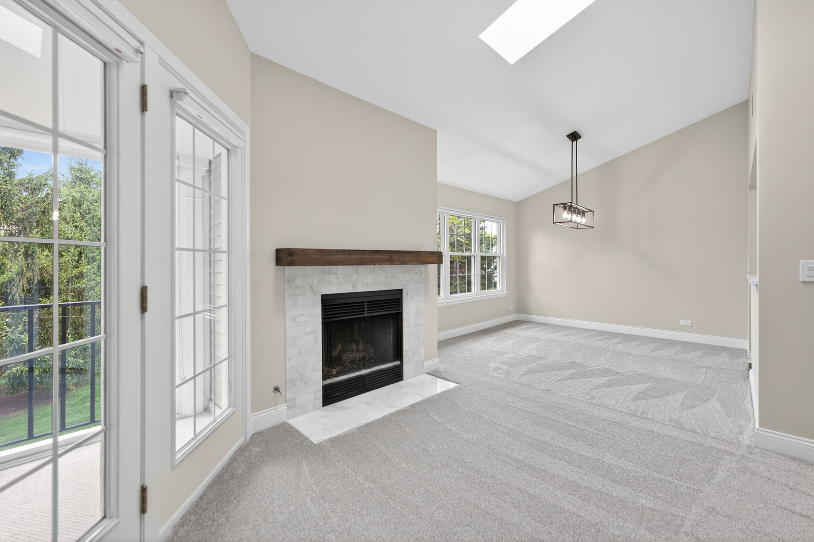802 Butternut Lane, Unit C Mount Prospect, IL 60056 - Photo 7 of 36 a view of an empty room with a fireplace and a window