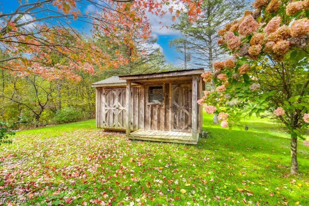 4100 Jade Road Northwest Carrollton, OH 44615 - Photo 7 of 37 View of outdoor structure with a lawn