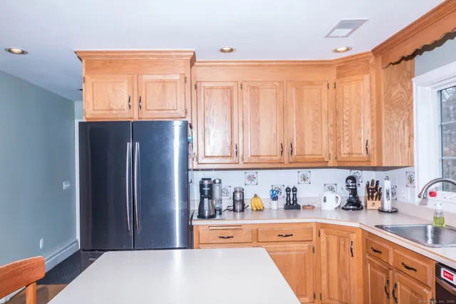 a kitchen with stainless steel appliances granite countertop a refrigerator and sink