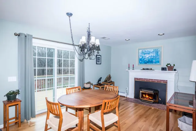 a living room with furniture a table and a fireplace