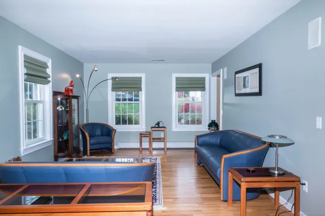 a living room with furniture and a piano