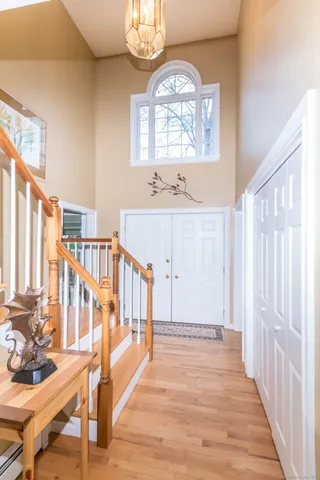 a view of a hallway with wooden floor and windows