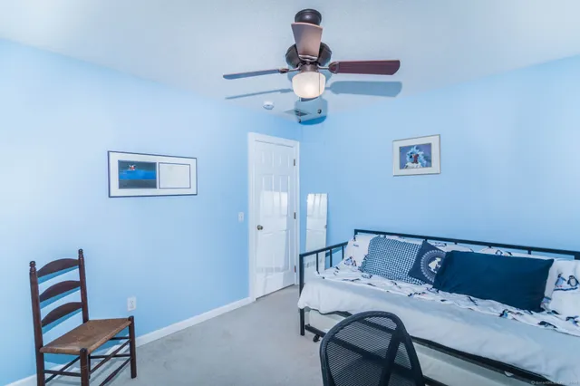 a bedroom with a bed and a desk