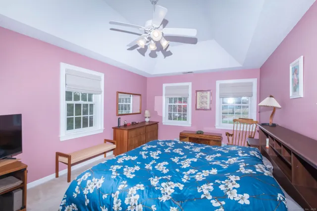 a bedroom with a bed dresser and a window