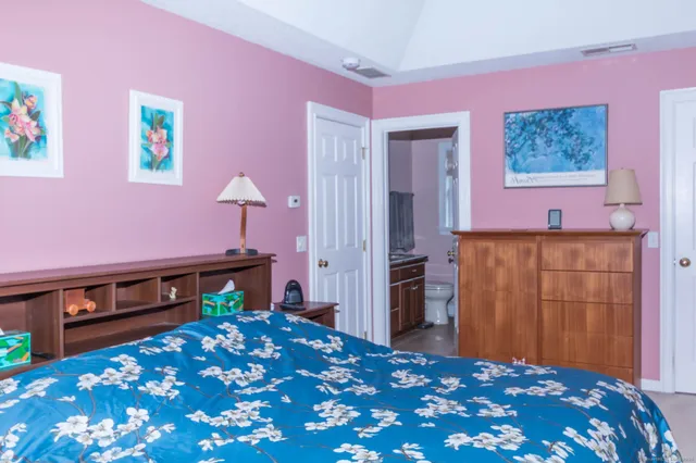 a bedroom with a bed and a dresser