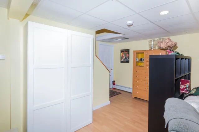a view of entryway with furniture and wooden floor
