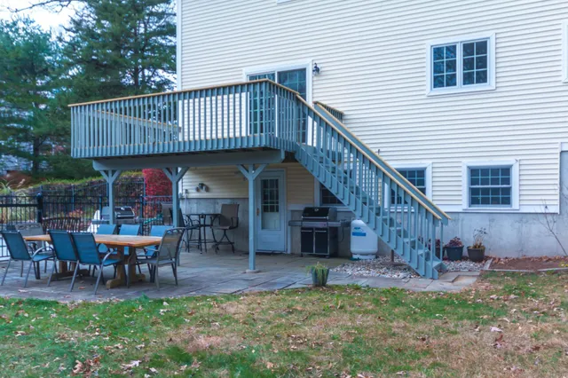 a view of a house with backyard and sitting area