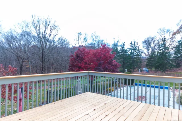 a balcony with wooden floor and fence