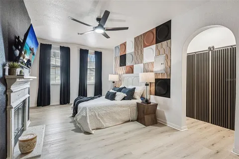 a bedroom with a large bed and a chandelier