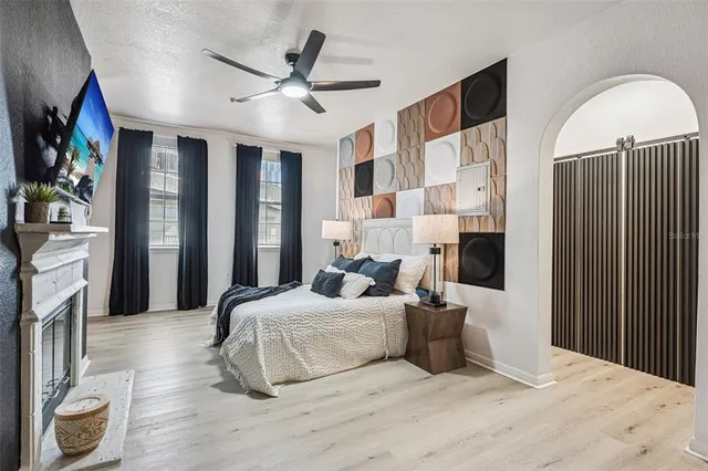 a bedroom with a large bed and a chandelier