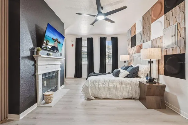 a bedroom with a bed and a fireplace