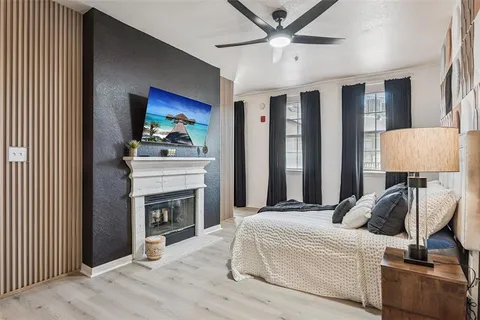 a bedroom with furniture and a fireplace