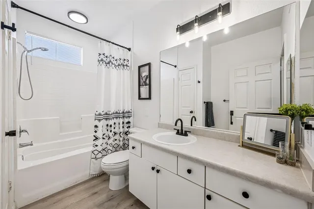 a bathroom with a double vanity sink toilet and shower