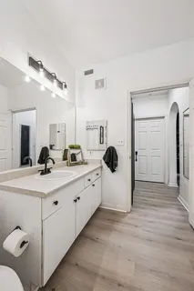 a bathroom with a double vanity sink and mirror