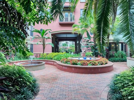 a front view of a house with a garden and plants