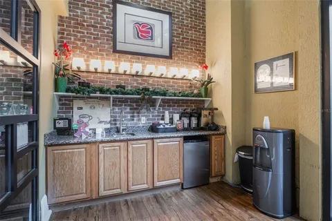 a view of a living room with wooden floor and furniture