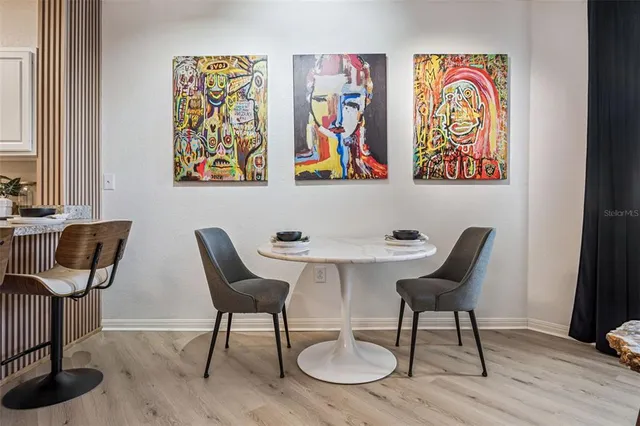 a view of a workspace with furniture and wooden floor