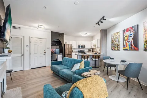 a living room with furniture and kitchen view